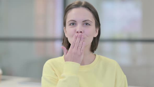 Portrait of Young Woman Giving Flying Kiss