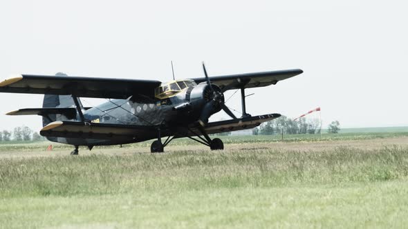 Small Old Propeller Plane is Moving Towards the Runway in Field for Takeoff