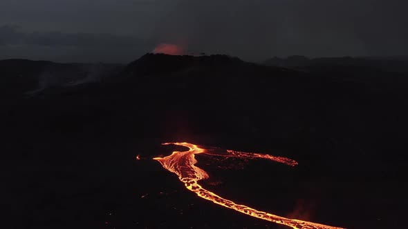 Drone Rising Over Stream Of Molten Lava Flowing From Volcan