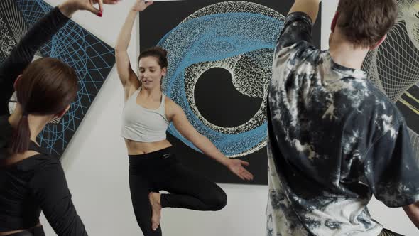 Group of People During Balance Training in the Room with Black and Blue Paintings