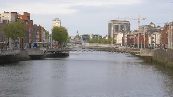 Millenium And Ha'penny Bridge Over Calm Water Of Liffey River From Grattan Bridge In Dublin, Ireland