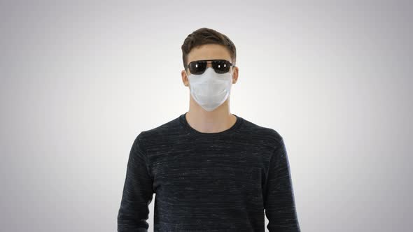 Blind Man in Face Mask and in Dark Glasses with Walking on Gradient Background