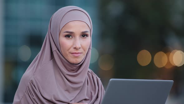 Closeup Focused Muslim Business Woman Wears Hijab Works with Laptop Browsing Web in Net Studying