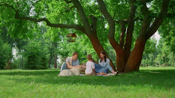 Resting Family with Dog on Picnic