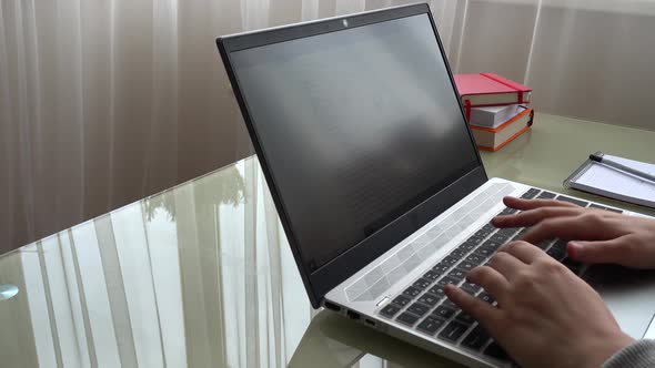 The girl working at home office hands on keyboard.