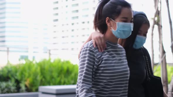 Young asian woman wearing protective face mask while working remotely on computer lapto