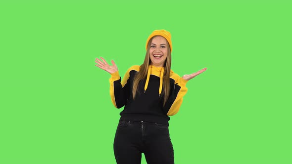 Modern Girl in Yellow Hat Is Laughing . Green Screen