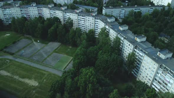 Tranquil Suburbs In A Big City. Multi Storey Buildings And A Large Green Area. An Old School Stadium