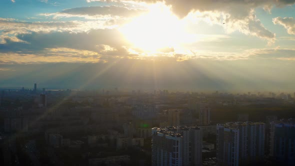 Aerial View of the City in the Rays of the Bright Sun at Sunset