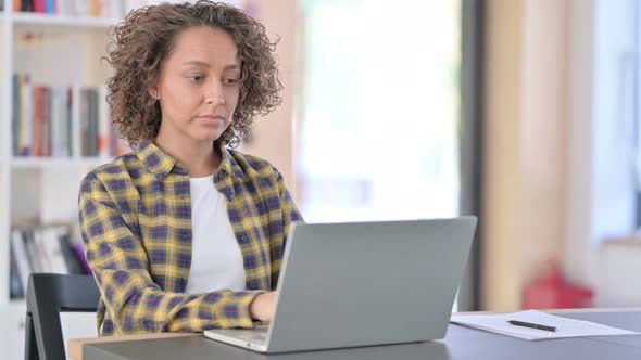 Beautiful Mixed Race Woman with Laptop Looking at the Camera 