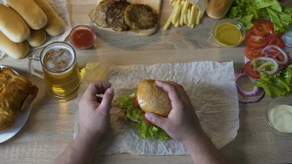 Guy Removing Fatty Cutlet from Burger, Keeping to Healthy Diet, Losing Weight