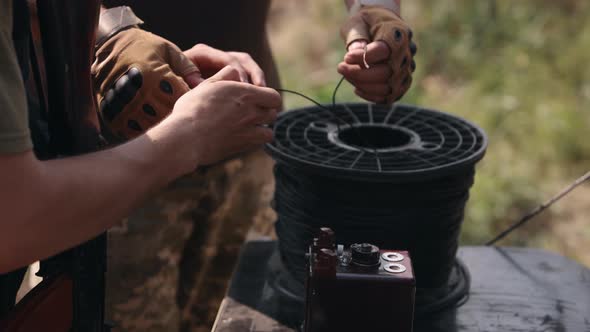 Soldier in Camouflage with Explosives in His Hands Miner Preparing Explosive