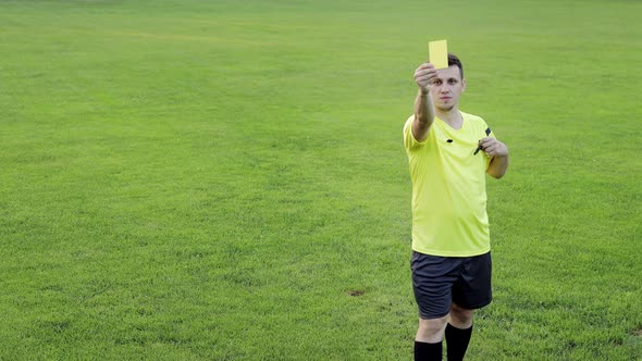 Soccer referee shows yellow card . Concept of sport, rules violation, offside.