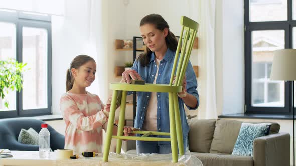 Mother and Daughter Sanding Old Chair with Sponge