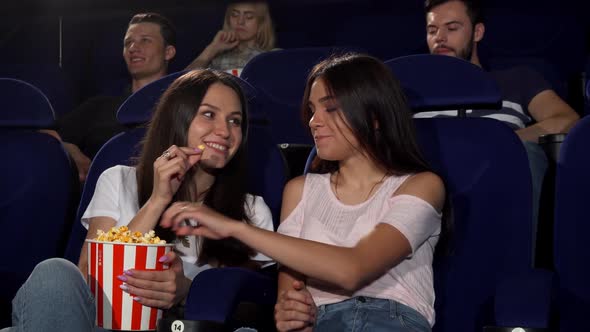 Beautiful Young Women Enjoying Watching Movies at the Cinema