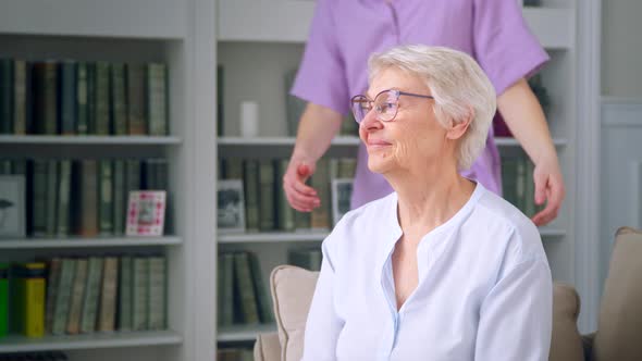 Women of different ages hugging and talking against the background of bookshelves