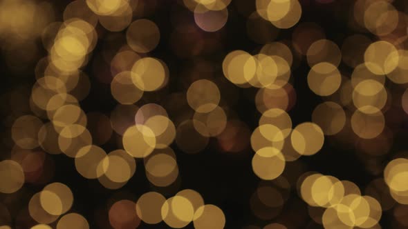 Abstract bokeh background, shining, glowing, blurred gold lights. 