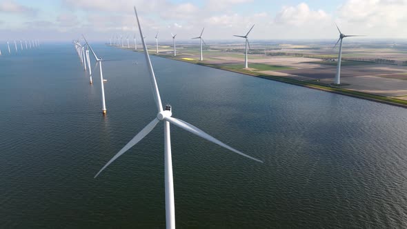 Offshore Windmill Park with Clouds and a Blue Sky Windmill Park in the Ocean Drone Aerial View with