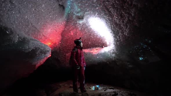 A Guy in an Ice Cave with a Lantern Light