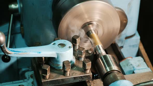 Turning Lathe in Action. Cutter Removes Metal Shavings From the Steel Billet, Close-up. Metal