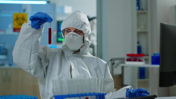 Neurologist with Ppe Suit Working at Vaccine Development Analysing Blood Sample