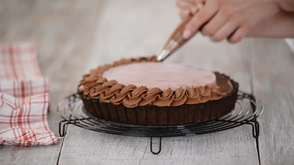 Confectioner Decorates Delicious Chocolate Tart with Cherry Confit and Chocolate Cream