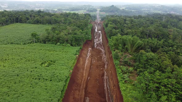 Land clearing for the highway from aerial drone footage of reverse motion