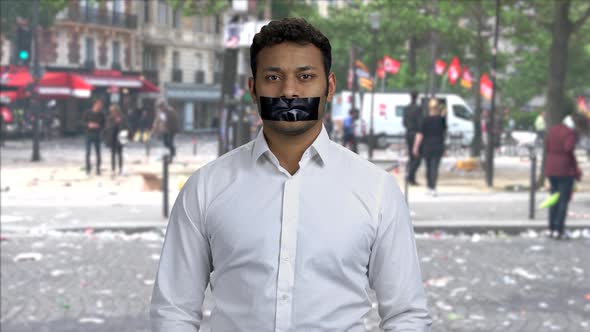 Silenced Man Holding Card with Inscriprion Freedom of Speech