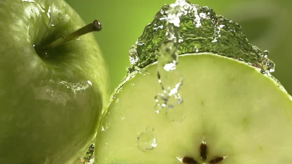 Slow Motion Shot of Green Apple Water Splashing Through Apple Slices