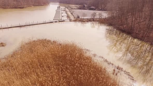 Rising aerial footage at a boat marina on an icy lake during the winter at a state park