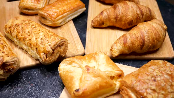 Fresh Pies, Croissants and Cakes Well-arranged on Wooden Boards