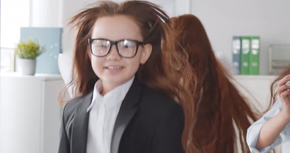 Excited Multiracial Little Business Team Dancing Throwing Papers in Office