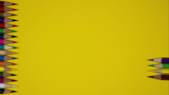 A Series of Sharp Colored Pencils on a Yellow Background. Stop Motion Animation