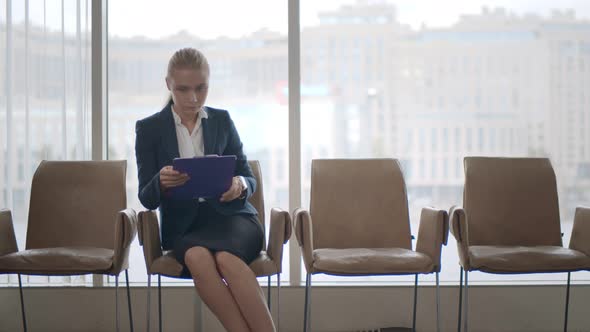 Stressed Woman Checking Time Waiting for Her Job Interview in Corporate Office