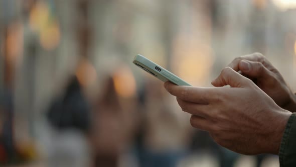 Close Up of Muslim Man Texting on Mobile Outdoors