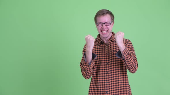 Happy Young Hipster Man Snapping Fingers and Getting Good News