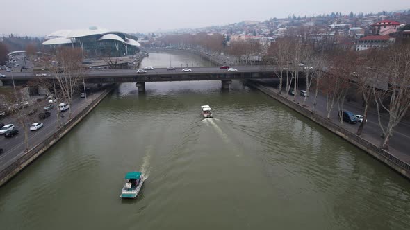 Boats In The River And Cars On The Bridge