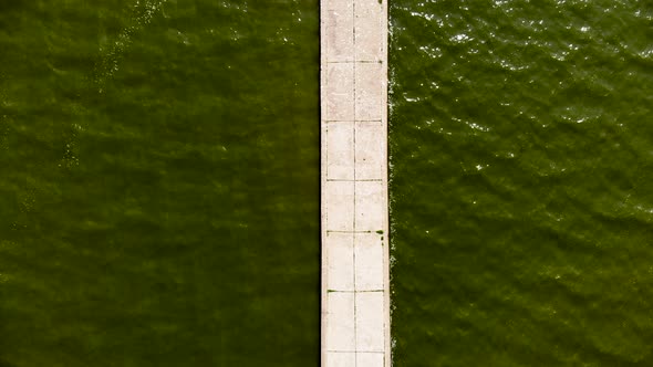 AERIAL: Flying Over Stone Pier Built on the Shore of Baltic Sea