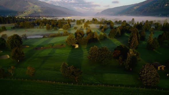 Drone Over Sunlit Misty Landscape Of Zell Am See At Dawn