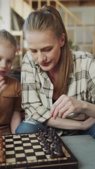 The Girl and Her Mother are Learning to Play Chess