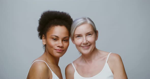 An Elderly and a Young Models Pose Together Smiling Looking at the Camera