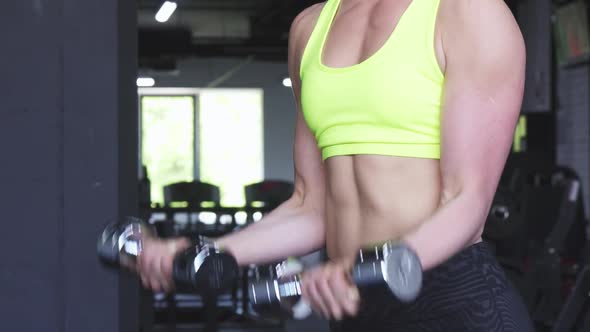 Cropped Shot of a Strong Athletic Woman Lifting Dumbbells