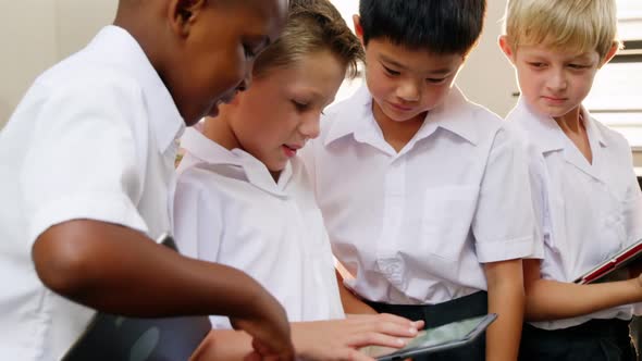 School kids using digital tablet in classroom