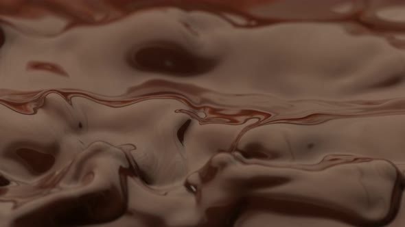 Super Slow Motion Detail Shot of Waving Melted Chocolate at 1000 Fps alt