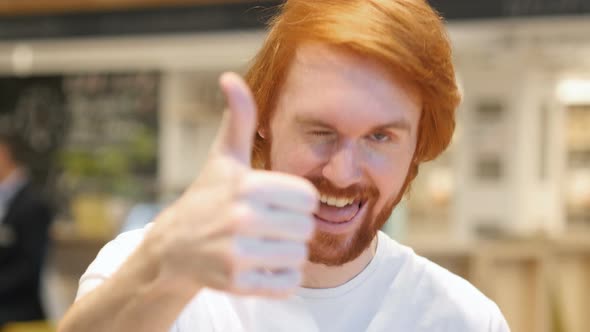 Redhead Man Pointing at Camera in Cafe, Thumbs Up