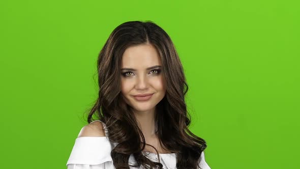 Girl Flirts and Sends Air Kisses To Everyone Around Her. Green Screen. Close Up. Slow Motion