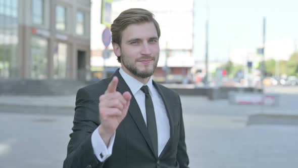 Businessman Pointing at the Camera Outdoor