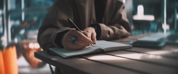 Business woman making notes in her notebook