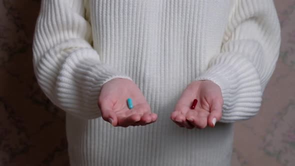 Hand Holding to Reveal Two Pills