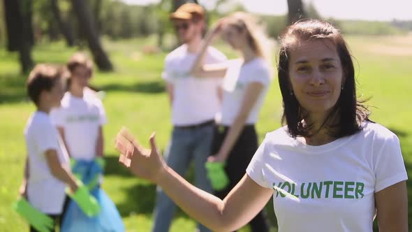 Portrait of Woman Family Recycle Plastic Bottle Activist in White Tshirt Cleaning Forest Park From